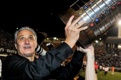 Coach Tite of Brazil's Corinthians holds the Copa Libertadores trophy after their victory against Argentina's Boca Juniors during their Copa Libertadores 2012 second leg final match at Pacaembu stadium in Sao Paulo on July 4, 2012. Brazil's Corinthians won the Copa Libertadores for the first time, defeating Argentina's Boca Juniors 2-0 in the second leg of the final before an ecstatic home crowd of 40,000. AFP PHOTO / Yasuyoshi CHIBA