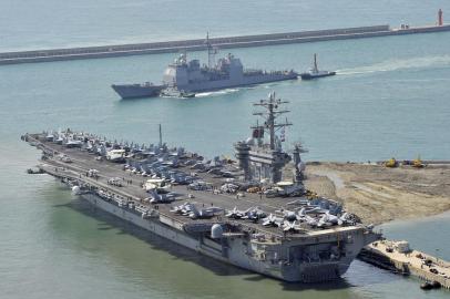 The nuclear powered aircraft carrier USS Nimitz (bottom) and the guided-missile cruisers USS Princeton (top) arrive at the southern port city of Busan on May 11, 2013. US warships led by the aircraft carrier USS Nimitz arrived in South Korea for sea drills following large-scale, annual joint land drills that have infuriated North Korea. AFP PHOTO / JUNG YEON-JE