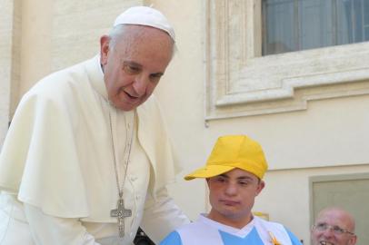 Pope Francis  invites a young boy suffering from Down Syndrome to rise above on papamobile at the end of  the weekly general audience in St Peter's square at the Vatican on June 19, 2013 AFP PHOTO / OSSERVATORE ROMANO