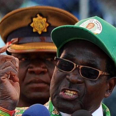 Zimbabwe's President Robert Mugabe addresses at a rally in Harare on July 28, 2013. Zimbabweans go to the polls on July 31 to choose between veteran President Robert Mugabe and long-time rival Morgan Tsvangirai. AFP PHOTO / ALEXANDER JOE