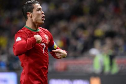 Portugal's forward Cristiano Ronaldo celebrates after scoring during the FIFA 2014 World Cup playoff football match Sweden vs Portugal at the Friends Arena in Solna near Stockholm on November 19, 2013 . AFP PHOTO/ JONATHAN NACKSTRAND