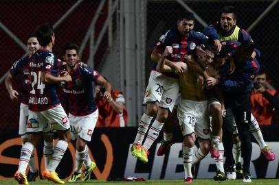 Argentina San Lorenzo midfielder Ignacio Piatti (without shirt) celebrates with teammates after scoring a goal against Botafogo during the Copa Libertadores 2014