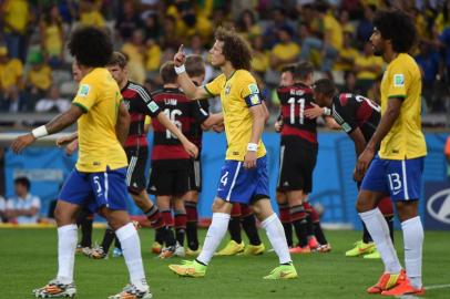 Brazil's defender David Luiz (C) gestures during the semi-final football match between Brazil and Germany at The Mineirao Stadium in Belo Horizonte on July 8, 2014, during the 2014 FIFA World Cup . AFP PHOTO / PEDRO UGARTE