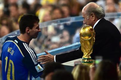 491717433FIFA President Joseph Blatter congratulates Argentina's forward and captain Lionel Messi after he won the golden balls award after the 2014 FIFA World Cup final football match between Germany and Argentina at the Maracana Stadium in Rio de Janeiro on July 13, 2014.    AFP PHOTO / NELSON ALMEIDAEditoria: SPOLocal: Rio de JaneiroIndexador: NELSON ALMEIDASecao: SoccerFonte: AFPFotógrafo: STF