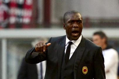 AC Milans Dutch coach Clarence Seedorf reacts during the Serie A football match between AC Milan and Parma at San Siro Stadium in Milan on March 16, 2014. AFP PHOTO / GIUSEPPE CACACE