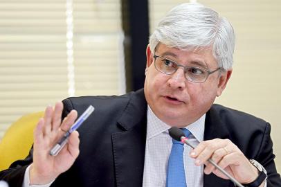 Brazilian attorney general Rodrigo Janot attends an administrative session at the Attorney General office, in Brasilia, on March 3, 2015. Janot investigates the participation of politicians in the Petrobras corruption scandal. Dozens of politicians from three parties, including from that of Brazilian President Dilma Rousseff, have been implicated in a corrupt network which laundered $4 billion of Brazil's state oil giant money. AFP PHOTO/EVARISTO SA