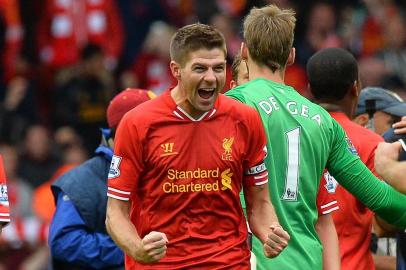 Liverpool's English midfielder Steven Gerrard celebrates at the final whistle in the English Premier League football match between Liverpool and Manchester United at the Anfield stadium in Liverpool, northwest England, on September 1, 2013. Liverpool won the game 1-0.  AFP PHOTO /RESTRICTED TO EDITORIAL USE. No use with unauthorized audio, video, data, fixture lists, club/league logos or live services. Online in-match use limited to 45 images, no video emulation. No use in betting, games or single club/league/player publications.