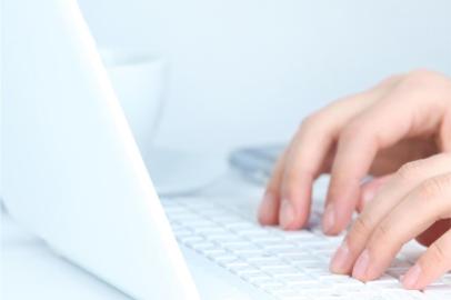 Human hands working on laptop on office background 