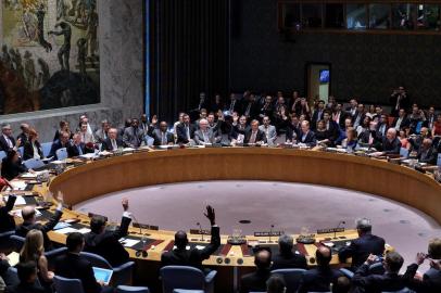 United Nations Security Council members vote on the Iran resolution at the UN headquarters in New York on July 20, 2015. The UN Security Council on Monday unanimously adopted a resolution that will clear a path for international sanctions crippling Iran's economy to be lifted. Representatives of all 15 countries on the council voted by raising their hands. "The draft resolution has been adopted unanimously," New Zealand ambassador Gerard van Bohemen, whose country holds the current presidency of the Security Council.  AFP PHOTO/JEWEL SAMAD