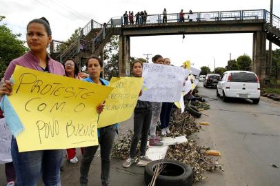  SAPUCAIA DO SUL, RS, BRASIL, 24-08-2015: Moradores interrompem o trânsito na RS-118, em Sapucaia do Sul. Os manifestantes protestam contra o atraso do Aluguel Social, que deveria ter sido pago no dia 10. (Foto: Mateus Bruxel / Agência RBS)