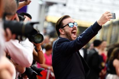 LOS ANGELES, CA - SEPTEMBER 20: Actor Ricky Gervais takes a selfie at the 67th Annual Primetime Emmy Awards at Microsoft Theater on September 20, 2015 in Los Angeles, California.   Frazer Harrison/Getty Images/AFP