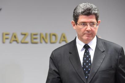 Brazilian Minister of Economy Joaquim Levy arrives for press conference at the Economy Ministry in Brasilia, on September 10, 2015. Standard & Poors financial services company downgraded Brazil, stripping the country of its investment-grade status and leaving President Dilma Rousseffs government on life support, risking an investor rush for the exits, analysts said Thursday. AFP PHOTO/EVARISTO SA