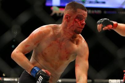 LAS VEGAS, NV - MARCH 5: Nate Diaz punches Conor McGregor during UFC 196 at the MGM Grand Garden Arena on March 5, 2016 in Las Vegas, Nevada.   Rey Del Rio/Getty Images/AFP