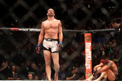 LAS VEGAS, NV - DECEMBER 12: Luke Rockhold (L) walks away from a bloodied Chris Weidman after a fourth-round TKO in their middleweight title fight during UFC 194 on December 12, 2015 in Las Vegas, Nevada.   Steve Marcus/Getty Images/AFP