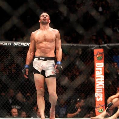 LAS VEGAS, NV - DECEMBER 12: Luke Rockhold (L) walks away from a bloodied Chris Weidman after a fourth-round TKO in their middleweight title fight during UFC 194 on December 12, 2015 in Las Vegas, Nevada.   Steve Marcus/Getty Images/AFP