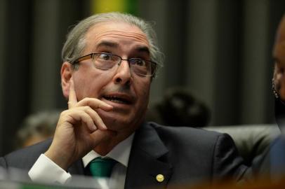  

The president of Brazil's Chamber of Deputies Eduardo Cunha --who earlier this month had been indicted by the Supreme Court of taking $5 million in bribes as part of a vast embezzlement and bribery network centered on the country's national oil company Petrobras-- gestures during the session in Brasília on March 17, 2016. Brazil's lower house of Congress launched a committee Thursday to consider impeaching President Dilma Rousseff over accusations she manipulated the government's accounts to boost public spending during her 2014 re-election campaign. AFP PHOTO / ANDRESSA ANHOLETE 
Andressa Anholete / AFP

Editoria: POL
Local: Brasília
Indexador: ANDRESSA ANHOLETE
Secao: politics (general)
Fonte: AFP
Fotógrafo: STR