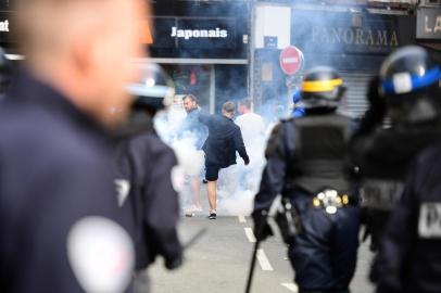 French policemen fire tear gas to disperse supporters gathering outside a bar in Lille, northern France, on June 15, 2016, on the sideline of the Euro 2016 European football championships.  / AFP PHOTO / LEON NEAL