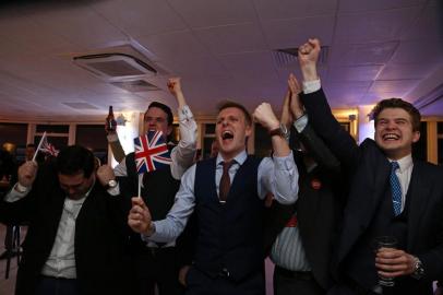 Leave.EU supporters wave Union flags and cheer as the results come in at the Leave.EU referendum party at Millbank Tower in central London early in the morning of June 24, 2016. First results from Britain's knife-edge referendum showed unexpectedly strong support for leaving the European Union on Friday, sending the pound plummeting as investors feared a historic blow against the 28-nation alliance.GEOFF CADDICK / AFP