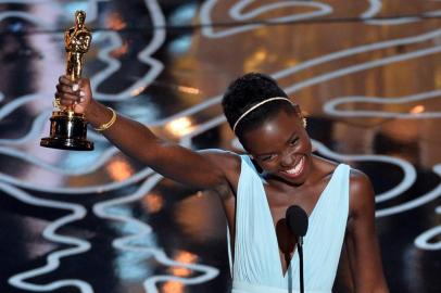 TOPSHOTSActress Lupita Nyongo accepts the Best Performance by an Actress in a Supporting Role award for 12 Years a Slave onstage during the Oscars at the Dolby Theatre on March 2, 2014 in Hollywood, California.   Kevin Winter/Getty Images/AFP