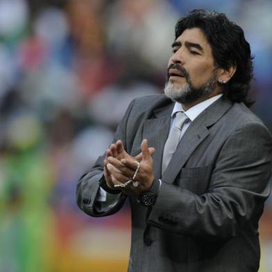 Argentinas coach Diego Maradona claps to his team during their Group B first round 2010 World Cup football match on June 12, 2010 at Ellis Park stadium in Johannesburg. NO PUSH TO MOBILE / MOBILE USE SOLELY WITHIN EDITORIAL ARTICLE - AFP PHOTO / DANIEL GARCIA