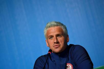  (FILES) This file photo taken on August 03, 2016 shows US swimmer Ryan Lochte holding a press conference in Rio de Janeiro, two days ahead of the opening ceremony of the Rio 2016 Olympic Games.Brazilian police have prevented two more U.S. swimmers from leaving the country after the Rio de Janeiro Olympics over the investigation of a robbery complaint by teammate Ryan Lochte. According to a report on O Globo Web site, swimmers Gunnar Bentz and Jack Conger were arrested and removed from their plane so Brazilian federal police could interview them Wednesday night. The U.S. Olympic Committee later confirmed their detention. / AFP PHOTO / MARTIN BUREAUEditoria: SPOLocal: Rio de JaneiroIndexador: MARTIN BUREAUSecao: swimmingFonte: AFPFotógrafo: STF