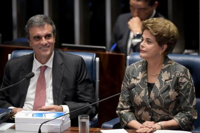 Suspended Brazilian President Dilma Rousseff gestures next to her attorney in the impeachment proceedings, Jose Eduardo Cardozo (L) before delivering her speech during the impeachment trial, at the National Congress in Brasilia, on August 29, 2016.Rousseff arrived at the Senate to defend herself confronting her accusers in a dramatic finale to a Senate impeachment trial likely to end 13 years of leftist rule in Latin America's biggest country. / AFP PHOTO / EVARISTO SA