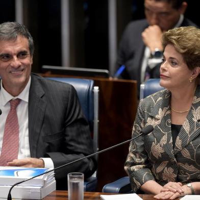 Suspended Brazilian President Dilma Rousseff gestures next to her attorney in the impeachment proceedings, Jose Eduardo Cardozo (L) before delivering her speech during the impeachment trial, at the National Congress in Brasilia, on August 29, 2016.Rousseff arrived at the Senate to defend herself confronting her accusers in a dramatic finale to a Senate impeachment trial likely to end 13 years of leftist rule in Latin Americas biggest country. / AFP PHOTO / EVARISTO SA