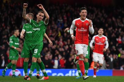 Arsenal's German midfielder Mesut Ozil (2R) celebrates scoring his hat trick and his team's sixth goal during the UEFA Champions League Group A football match between Arsenal and Ludogorets Razgrad at The Emirates Stadium in London on October 19, 2016. 
BEN STANSALL / AFP