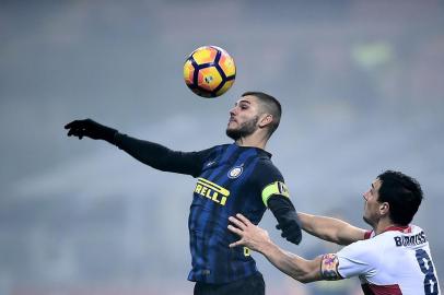 Inter Milan's forward from Argentina Mauro Icardi (L)  vies with Genoa's defender from Argentina Nicolas Burdisso during the italian Serie A football match Inter-Milan vs Genoa at the San Siro Stadium in Milan on December 12, 2016. / AFP PHOTO / FILIPPO MONTEFORTE