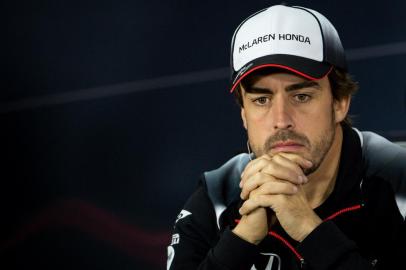 McLaren Hondas Spanish driver Fernando Alonso gestures during the drivers press conference ahead of the Formula One Bahrain Grand Prix at the Sakhir circuit in the desert south of the Bahraini capital, Manama, on March 31, 2016.Alonso will not take part in this weekends Grand Prix in Bahrain for medical reasons following his dramatic, death-defying crash at the Australian GP. / AFP / ANDREJ ISAKOVIC