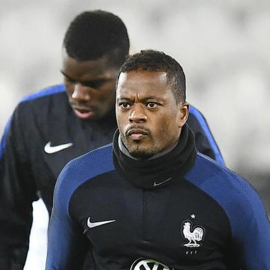 (FILES) This file photo taken on November 14, 2016 shows Frances defender Patrice Evra running during a training session at the Bollaert stadium in Lens on November 14, 2016, on the eve of the friendly football match against Ivory Coast. French international defender of Juventus Turin Patrice Evra, 35, will commit for 18 months to Marseille, announced January 23, according to various French media.FRANCK FIFE / AFP