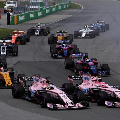 MONTREAL, QC - JUNE 11: Esteban Ocon of France driving the (31) Sahara Force India F1 Team VJM10 and Sergio Perez of Mexico driving the (11) Sahara Force India F1 Team VJM10 battle for position into turn 1 at the start during the Canadian Formula One Grand Prix at Circuit Gilles Villeneuve on June 11, 2017 in Montreal, Canada.   Mark Thompson/Getty Images/AFP