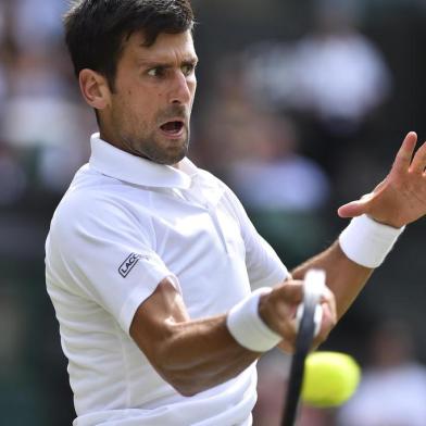 Serbia's Novak Djokovic returns against Slovakia's Martin Klizan during their men's singles first round match on the second day of the 2017 Wimbledon Championships at The All England Lawn Tennis Club in Wimbledon, southwest London, on July 4, 2017. / AFP PHOTO / Glyn KIRK / RESTRICTED TO EDITORIAL USE