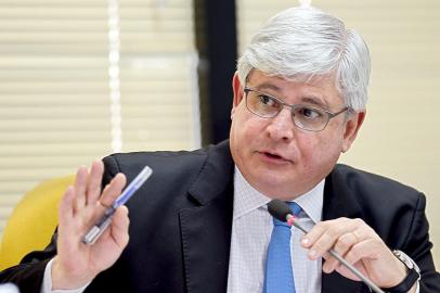 Brazilian attorney general Rodrigo Janot attends an administrative session at the Attorney General office, in Brasilia, on March 3, 2015. Janot investigates the participation of politicians in the Petrobras corruption scandal. Dozens of politicians from three parties, including from that of Brazilian President Dilma Rousseff, have been implicated in a corrupt network which laundered $4 billion of Brazils state oil giant money. AFP PHOTO/EVARISTO SA
