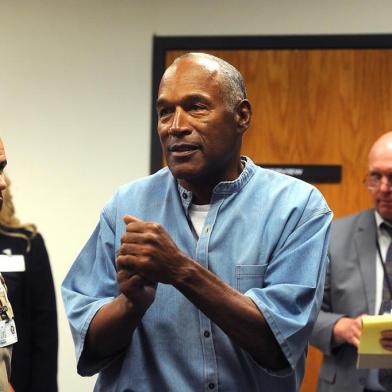 O.J. Simpson (C) reacts after learning he was granted parole during his parole hearing at the Lovelock Correctional Center in Lovelock, Nevada on July 20, 2017.Disgraced former American football star O.J. Simpson was granted his release from prison on Thursday after serving nearly nine years behind bars for armed robbery.A four-member parole board in the western US state of Nevada voted unanimously to free the 70-year-old Simpson after a public hearing broadcast live by US television networks. / AFP PHOTO / POOL / Jason Bean / RESTRICTED TO EDITORIAL USE - MANDATORY CREDIT AFP PHOTO /POOL/Reno Gazette-Journal/ Jason Bean - NO MARKETING NO ADVERTISING CAMPAIGNS - DISTRIBUTED AS A SERVICE TO CLIENTS