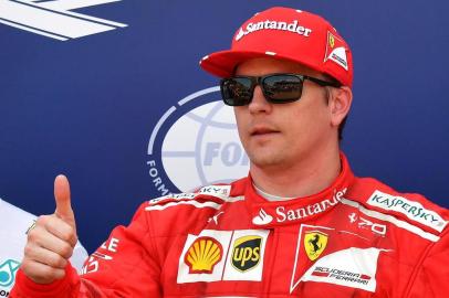 Ferraris Finnish driver Kimi Raikkonen celebrates after winning the pole position during the qualifying session at the Monaco street circuit, on May 27, 2017 in Monaco, a day ahead of the Monaco Formula 1 Grand Prix.  / AFP PHOTO / PASCAL GUYOT