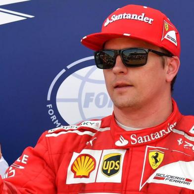 Ferraris Finnish driver Kimi Raikkonen celebrates after winning the pole position during the qualifying session at the Monaco street circuit, on May 27, 2017 in Monaco, a day ahead of the Monaco Formula 1 Grand Prix.  / AFP PHOTO / PASCAL GUYOT