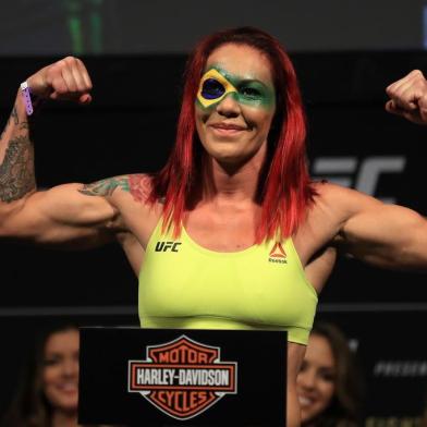 ANAHEIM, CA - JULY 28: Cris Cyborg of Brazil poses for fans on the scale during the UFC 214 weigh-in at Honda Center on July 28, 2017 in Anaheim, California. Cyborg will fight Tonya Evinger in the featherweight title bout on July 28, 2017 in Anaheim, California.   Sean M. Haffey/Getty Images/AFP