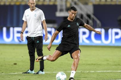 Real Madrid's French head coach Zinedine Zidane (L) looks on as Real Madrid's forward Cristiano Ronaldo shoots the ball during a training session before the UEFA Super Cup 2017 football match between Real Madrid and Manchester United at the National Arena Filip II on August 7, 2017 in Skopje. / AFP PHOTO / NIKOLAY DOYCHINOV