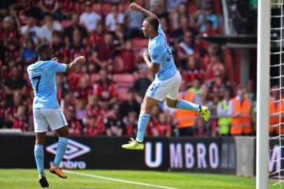 Manchester Citys Brazilian striker Gabriel Jesus (R) celebrates with Manchester Citys English midfielder Raheem Sterling after scoring their first goal during the English Premier League football match between Bournemouth and Manchester City at the Vitality Stadium in Bournemouth, southern England on August 26, 2017. / AFP PHOTO / Glyn KIRK / RESTRICTED TO EDITORIAL USE. No use with unauthorized audio, video, data, fixture lists, club/league logos or live services. Online in-match use limited to 75 images, no video emulation. No use in betting, games or single club/league/player publications.  / 