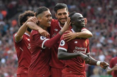 Liverpools Senegalese midfielder Sadio Mane (R) celebrates with teammates after scoring their second goal during the English Premier League football match between Liverpool and Arsenal at Anfield in Liverpool, north west England on August 27, 2017. / AFP PHOTO / Anthony Devlin / RESTRICTED TO EDITORIAL USE. No use with unauthorized audio, video, data, fixture lists, club/league logos or live services. Online in-match use limited to 75 images, no video emulation. No use in betting, games or single club/league/player publications.  / 