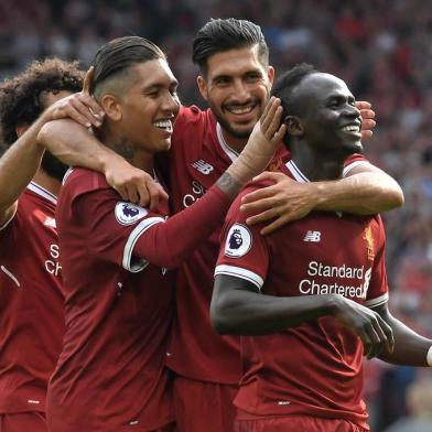 Liverpools Senegalese midfielder Sadio Mane (R) celebrates with teammates after scoring their second goal during the English Premier League football match between Liverpool and Arsenal at Anfield in Liverpool, north west England on August 27, 2017. / AFP PHOTO / Anthony Devlin / RESTRICTED TO EDITORIAL USE. No use with unauthorized audio, video, data, fixture lists, club/league logos or live services. Online in-match use limited to 75 images, no video emulation. No use in betting, games or single club/league/player publications.  / 