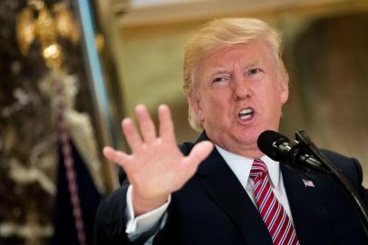 NEW YORK, NY - AUGUST 15: US President Donald Trump speaks following a meeting on infrastructure at Trump Tower, August 15, 2017 in New York City. He fielded questions from reporters about his comments on the events in Charlottesville, Virginia and white supremacists.   Drew Angerer/Getty Images/AFP