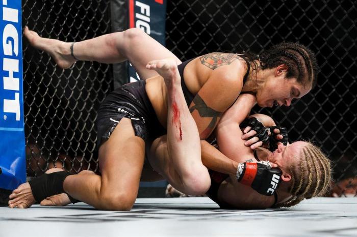 EDMONTON, AB - SEPTEMBER 09: Amanda Nunes, top, fights Valentina Shevchenko during UFC 215 at Rogers Place on September 9, 2017 in Edmonton, Canada.   Codie McLachlan/Getty Images/AFP