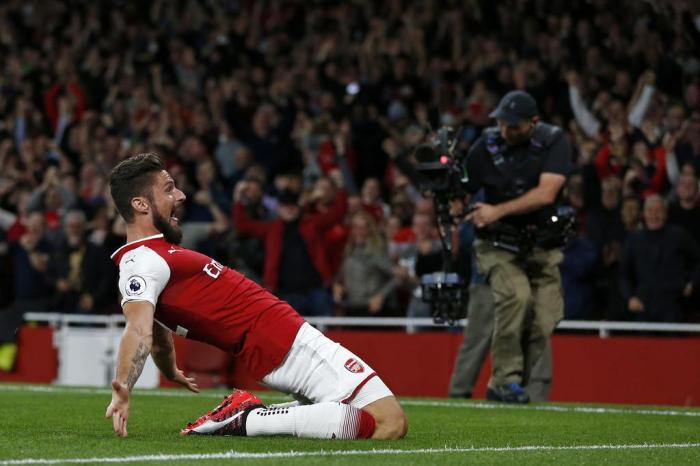 Arsenals French striker Olivier Giroud celebrates scoring Arsenals fourth goal during the English Premier League football match between Arsenal and Leicester City at the Emirates Stadium in London on August 11, 2017. / AFP PHOTO / Ian KINGTON / RESTRICTED TO EDITORIAL USE. No use with unauthorized audio, video, data, fixture lists, club/league logos or live services. Online in-match use limited to 75 images, no video emulation. No use in betting, games or single club/league/player publications.  /