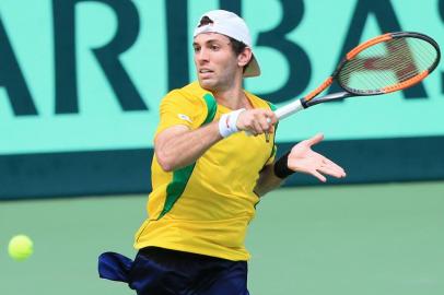 Guilherme Clezar of Brazil hits a return to Yuichi Sugita of Japan during the first tennis match of the Davis Cup World Group playoff between Japan and Brazil in Osaka on September 15, 2017.  / AFP PHOTO / JIJI PRESS / STR / Japan OUT