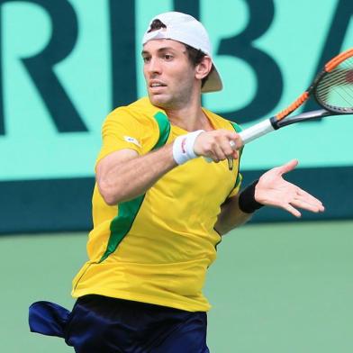 Guilherme Clezar of Brazil hits a return to Yuichi Sugita of Japan during the first tennis match of the Davis Cup World Group playoff between Japan and Brazil in Osaka on September 15, 2017.  / AFP PHOTO / JIJI PRESS / STR / Japan OUT