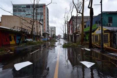 Fallen trees are seen on a street after the passage of Hurricane Maria, in San Juan, Puerto Rico, on September 20, 2017.
Maria slammed into Puerto Rico on, cutting power on most of the US territory as terrified residents hunkered down in the face of the islands worst storm in living memory. After leaving a deadly trail of destruction on a string of smaller Caribbean islands, Maria made landfall on Puerto Ricos southeast coast around daybreak, packing winds of around 150mph (240kph).
 / AFP PHOTO / HECTOR RETAMAL