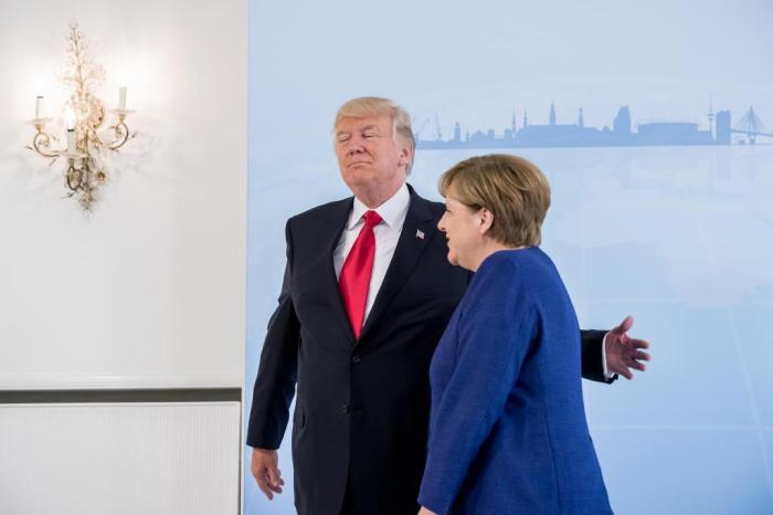 German Chancellor Angela Merkel (R) and US President Donald Trump  leave for a bilateral meeting on the eve of the G20 summit in Hamburg, northern Germany, on July 6, 2017.
Leaders of the worlds top economies will gather from July 7 to 8, 2017 in Germany for likely the stormiest G20 summit in years, with disagreements ranging from wars to climate change and global trade. / AFP PHOTO / POOL / Michael Kappeler