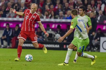 Bayern Munichs Dutch midfielder Arjen Robben (L) plays the ball during the German First division Bundesliga football match FC Bayern Munich vs VfL Wolfsburg in Munich, southern Germany, on September 22, 2017. / AFP PHOTO / Guenter SCHIFFMANN / RESTRICTIONS: DURING MATCH TIME: DFL RULES TO LIMIT THE ONLINE USAGE TO 15 PICTURES PER MATCH AND FORBID IMAGE SEQUENCES TO SIMULATE VIDEO. == RESTRICTED TO EDITORIAL USE == FOR FURTHER QUERIES PLEASE CONTACT DFL DIRECTLY AT + 49 69 650050
